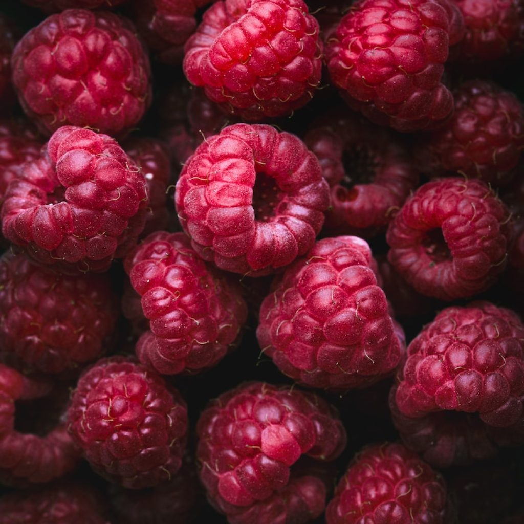 a bunch of raspberries sitting on top of each other